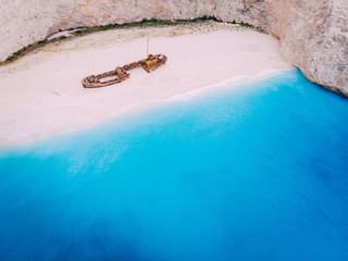 An old rusted ship, wrecked, lies on the seashore. Navagio Bay Shipwreck Beach Greece, Zakynthos
