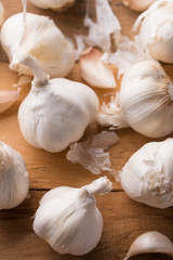 A lot of garlic on a wooden background. Close-up
