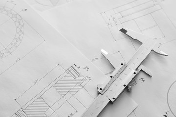 Vernier caliper and drawings on table of engineer