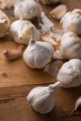 A lot of garlic on a wooden background, top view. Background for design