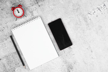 Time to plan. Phone and notebook layout with pen and coffee on a flat lay. View from above. Place...