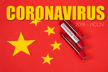 top view of samples with coronavirus test and coronavirus, 2019-ncov lettering near red chinese flag