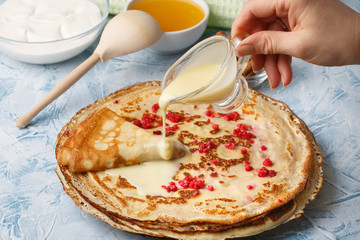 Delicious Russian pancakes with sour cream and honey cooked for Shrovetide celebration
