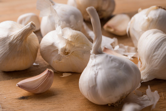 A lot of garlic on a wooden background. Close up, horizontal photo