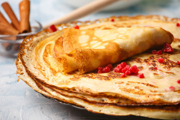 Delicious Russian pancakes with sour cream and honey cooked for Shrovetide celebration