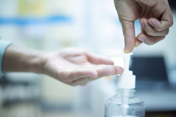 Close up hand using alcohol gel.