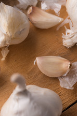 A lot of garlic on a wooden background, top view. Background for design