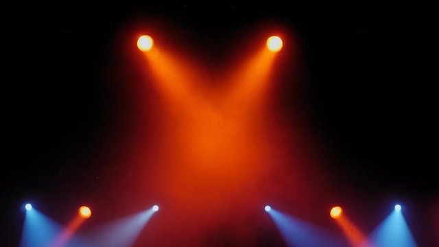 Stage lights with smoke on concert. Background in show. Stage lights and smoke. Colored lights on an empty concert stage with smoke.