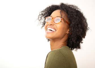 side portrait smiling young black woman with eyeglasses against white isolated background