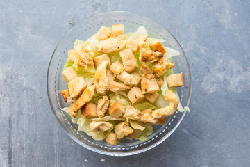 Caesar salad with toast, lettuce and grilled chicken breast