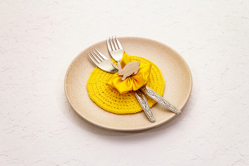 Easter table setting on textured white putty background. Spring holiday card template. Cutlery,...