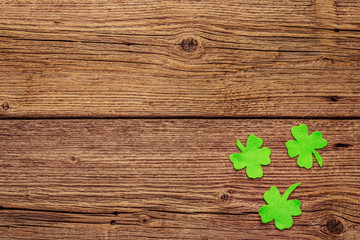 Felt clover leaves on old wooden background. Good luck symbol, St.Patrick's Day concept