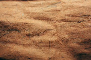 Close up view of abstract brown texture and background made with recycled paper. 