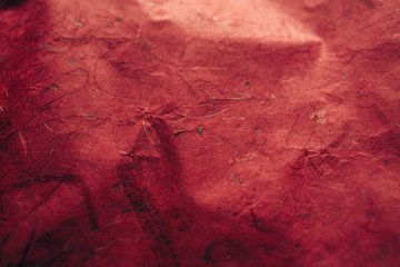 Close up view of red abstract texture and background made of recycled paper. 