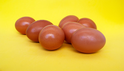 natural diet Easter eggs in orange color lie on a yellow background