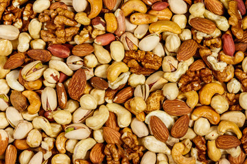 Background of mixed nuts (walnuts, pistachio, almond, peanut, cashew, hazelnut). Healthy eating concept