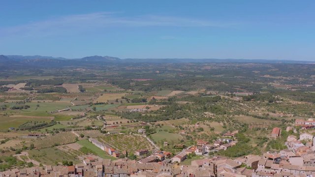 Aerial picturesque landscape of a valley with a town on top of the hill. Horta de Sant Joan village is located on Els Ports of Beceite, Tarragona, Spain