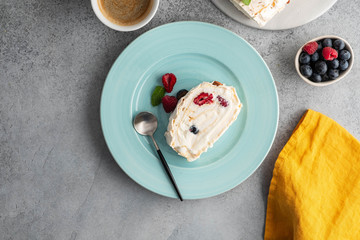 Meringue roll cake with cream and raspberries. Roulade, summer dessert, closeup.