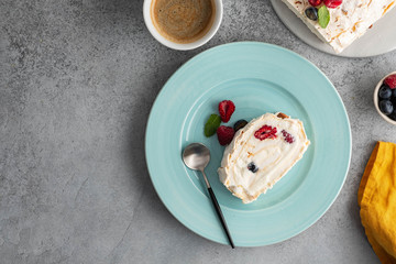 Meringue roll cake with cream and raspberries. Roulade, summer dessert, closeup.