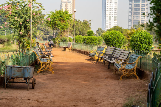 Mumbai, India -  Benches and a walking path in the Hanging Garden park in Malbar Hill neighborhood of Bombay