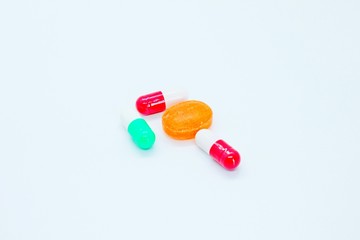 Pills, vitamins, medicines located on a white background