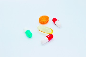 Pills, vitamins, medicines located on a white background