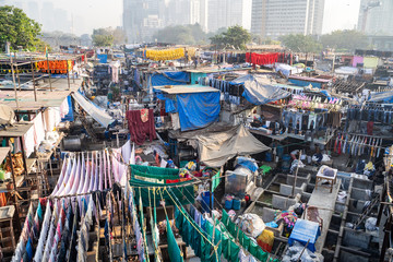Fototapeta na wymiar Mumbai, India - The Dhobi Ghat is a well known open air laundromat where thousands of people work daily washing and drying clothing and linens