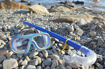 Diving. Mask and snorkel for scuba diving are on the seashore, the beach is stone. Diving with a...