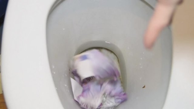 the money to flush with a stream of water in a dirty toilet