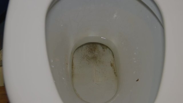 the money to flush with a stream of water in a dirty toilet