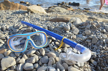 Diving. Mask and snorkel for scuba diving are on the seashore, the beach is stone. Diving with a...