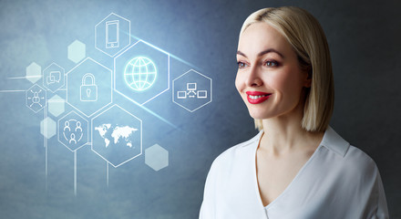 Blonde business woman looks on the different digital icons.