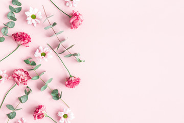Flowers composition. Pink flowers and eucalyptus branches on pink background. Valentines day, mothers day, womens day concept. Flat lay, top view - 327520490