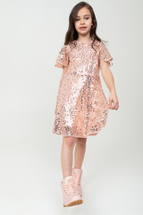 Fototapeta premium Full-length teenager girl in shiny party dress posing on a white studio background