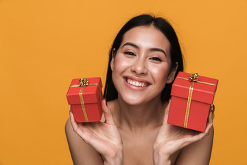 Beauty portrait of half-naked woman smiling while holding present boxes