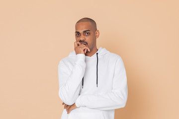 Pensive African guy with a white sweatshirt