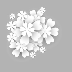 Paper flower. White flowers cut from paper on a gray background, isolated elements of floral design. Greeting card template. 