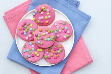 Pink cookies with colorful smarties.
