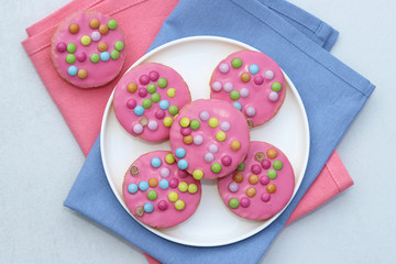 Pink cookies with colorful smarties.