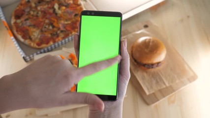 Vertical chromakey mockup for ordering food, watching app or pay delivery service closeup. Casual life of female person web tracking online menu store using touchscreen cellphone pov. Scroll up, right - Powered by Adobe