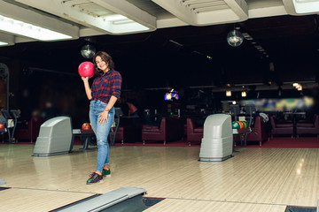 Fototapeta premium beautiful girl plays bowling in bowling club
