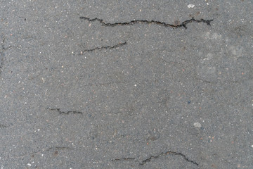 Texture, background of paved grey road with stripes