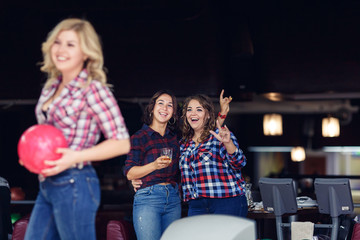 nice blond girl with bowling ball, girlfriends in background