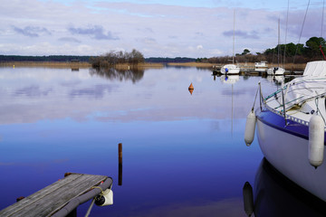 Fototapeta na wymiar marina in blue water lake of biscarosse landes france
