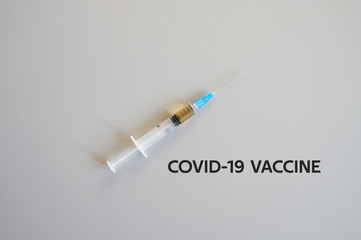 syringe with injection vaccine on a gray background. medicine plastic disposable vaccination...
