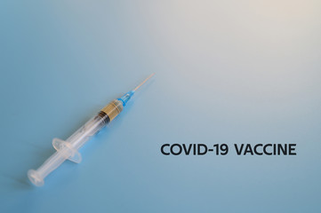 syringe with injection vaccine on a blue background. medicine plastic disposable vaccination...