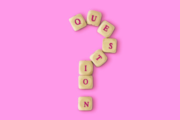 Question mark made of wooden letter blocks on pink background - Concept of listening and support to...