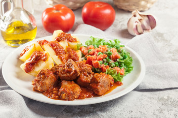 Braised pork meat stew served with potatoes