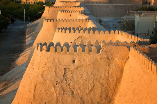 City walls of the ancient city of Khiva at the sunset , Uzbekistan
