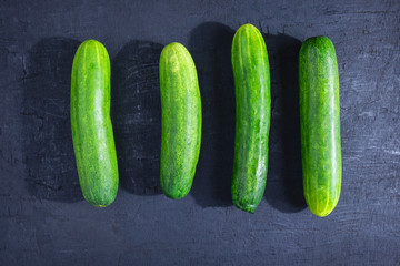 .Fresh cucumber on black background